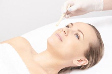 Sugar hair removal from woman body. Wax epilation spa procedure. Procedure beautician female....
