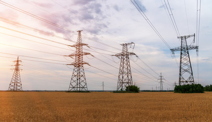 high-voltage power lines at sunset. electricity distribution station. high voltage electric transmission tower