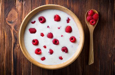 raspberry berries yoghurt  eating healthy food Wooden plate spoon Vintage background
