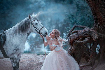 A fairy in a tender vintage dress hugs a unicorn. Fantastic magical, radiant horse. Background...