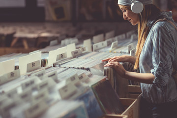 Attractive girl in a vinyl store