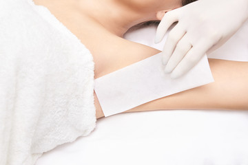 Sugar hair removal from woman body. Wax epilation spa procedure. Procedure beautician female. Armpit
