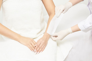 Fototapeta na wymiar Sugar hair removal from woman body. Wax epilation spa procedure. Procedure beautician female. Forearm