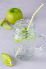 Refreshing water with apple in a glass jar