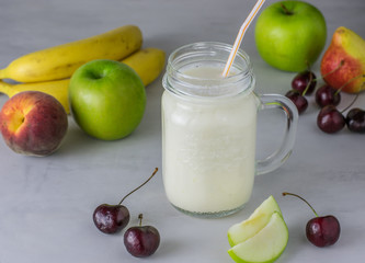 Smoothies in a glass jar and fresh fruit