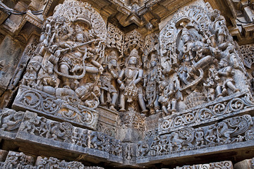 Ornate wall panel reliefs depicting dancing Shiva on the left and dancing Sarswati on the right, Hoysaleshwara temple, Halebidu, Karnataka