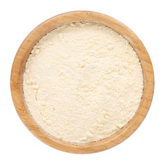 Fine cornmeal or corn flour in wooden bowl isolated on white. Top view.