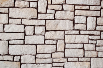 wall made of stone of different shape beige