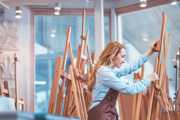 Young attractive artist at the easel