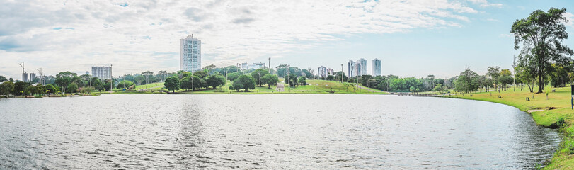 Panoramic view of the lake of a park on a beautiful sunny day. The water of the lake with some...