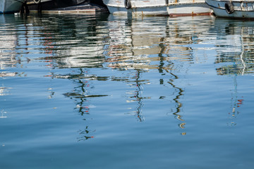 Reflections of Fishing Boats Moored at the Harbor