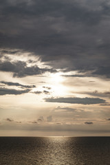 Obraz premium golden dark sunset and clouds over the sea