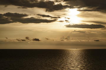 golden dark sunset and clouds over the sea
