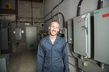 Man Technician servicing at work on electric room