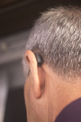Deaf man hearing aid ear