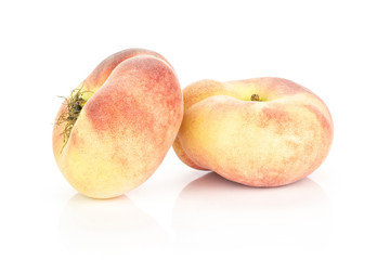 Two fresh Saturn peaches isolated on white background ripe fruit.