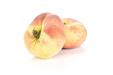 Two fresh ripe Saturn peaches isolated on white background.