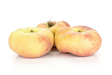 Three fresh ripe Saturn peaches isolated on white background.
