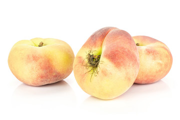 Three fresh Saturn peaches isolated on white background ripe fruit.