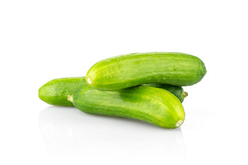 Three fresh green mini cucumbers stack isolated on white background.