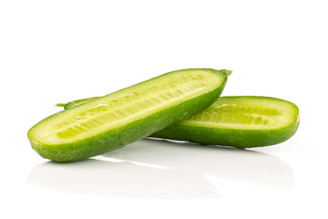 Two fresh green mini cucumber section halves isolated on white background.
