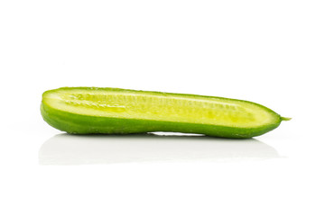 One fresh mini cucumber section half isolated on white background.