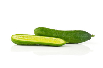 One fresh green mini cucumber and section half isolated on white background.