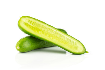One fresh green mini cucumber with section half isolated on white background.