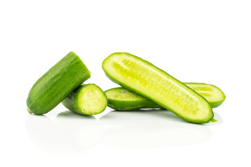Sliced fresh green mini cucumbers halves isolated on white background.