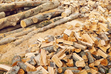 Stacks of firewood in the sawmill. Pile of firewood. Firewood background