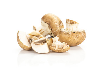 Sliced brown champignons two whole and three slices isolated on white background fresh raw mushrooms.