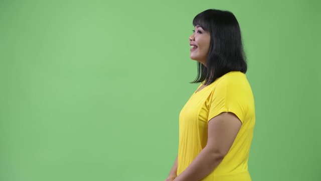 Profile view of beautiful Asian woman smiling