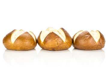 Fresh Bavarian bread buns in row isolated on white background three baked loaves.