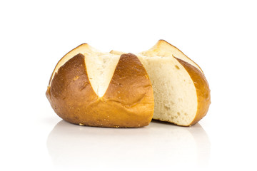 Sliced Bavarian bread bun one cut in two halves isolated on white background fresh baked loaves.