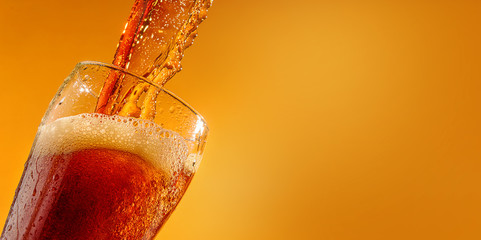 Cold fresh beer is poured into a glass