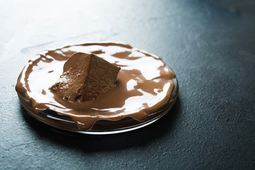 Molten milk chocolate on glass plate with copy space