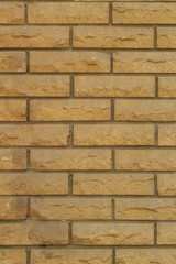 Background of a wall made of bricks made of sandstone texture