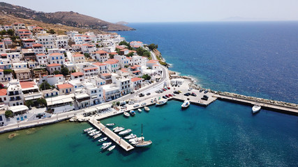 Fototapeta na wymiar Aerial drone bird's eye view of picturesque village of Batsi with traditional taverns and clear water beach, Andros island, Cyclades, Greece