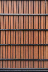 The surface of the wooden fence, with metal partitions. wall, view of a vertical board. texture, background