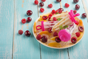 Homemade yogurt skewers, ice cream on sticks, top view, flat lay with empty space for the inscription.Bright color, summer mood.