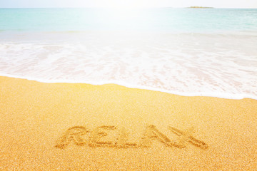 Beautiful sunny beach by the blue sea. Inscription 