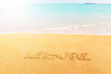 Fototapeta na wymiar Beautiful sunny beach by the blue sea. Inscription 