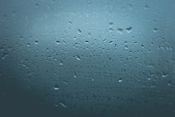 misted glass. Water on the car glass. beautiful desktop, blue, background.