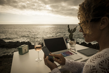 beautiful assistent professional lady at work in alternative freedom concept office in front of the ocean. enjoy a different lifestyle and work with social media like digital nomad - obrazy, fototapety, plakaty