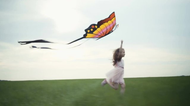 girl running around with a kite on the field. Freedom concept.