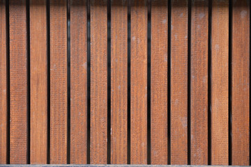 The surface of the wooden fence, with metal partitions. wall, view of a vertical board. texture, background