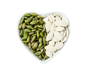 Pumpkin seeds in heart bowl shape.