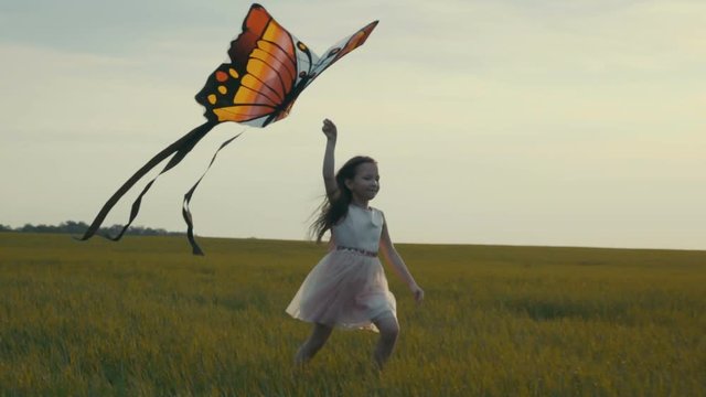 girl running around with a kite on the field. Freedom concept.