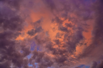 Colorful with red, orange and blue dramatic sky on the clouds for abstract background. Romantic sunset background with beautiful blue, red and yellow clouds.