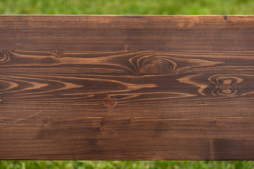 Brown natural wood texture on green background